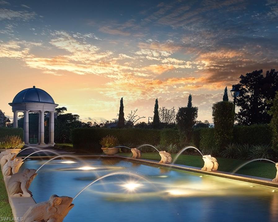 Pool at dusk featuring a patio