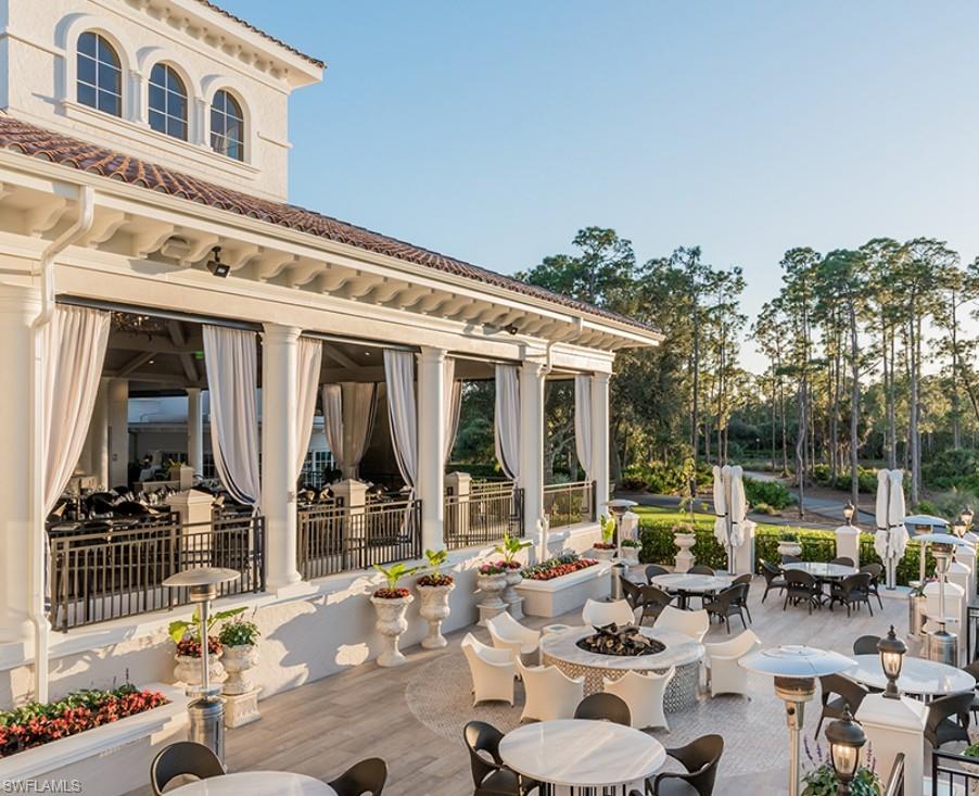 View of patio featuring outdoor dining space and a fire pit