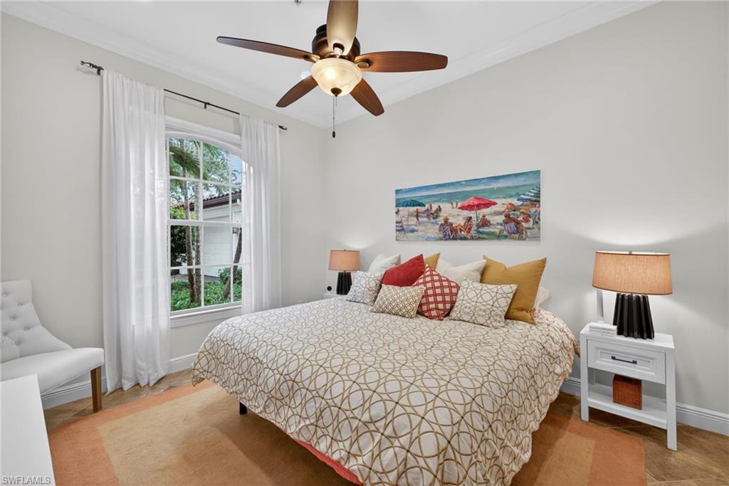 Bedroom featuring a ceiling fan and crown molding