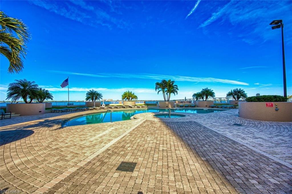Community pool featuring a community hot tub and a patio