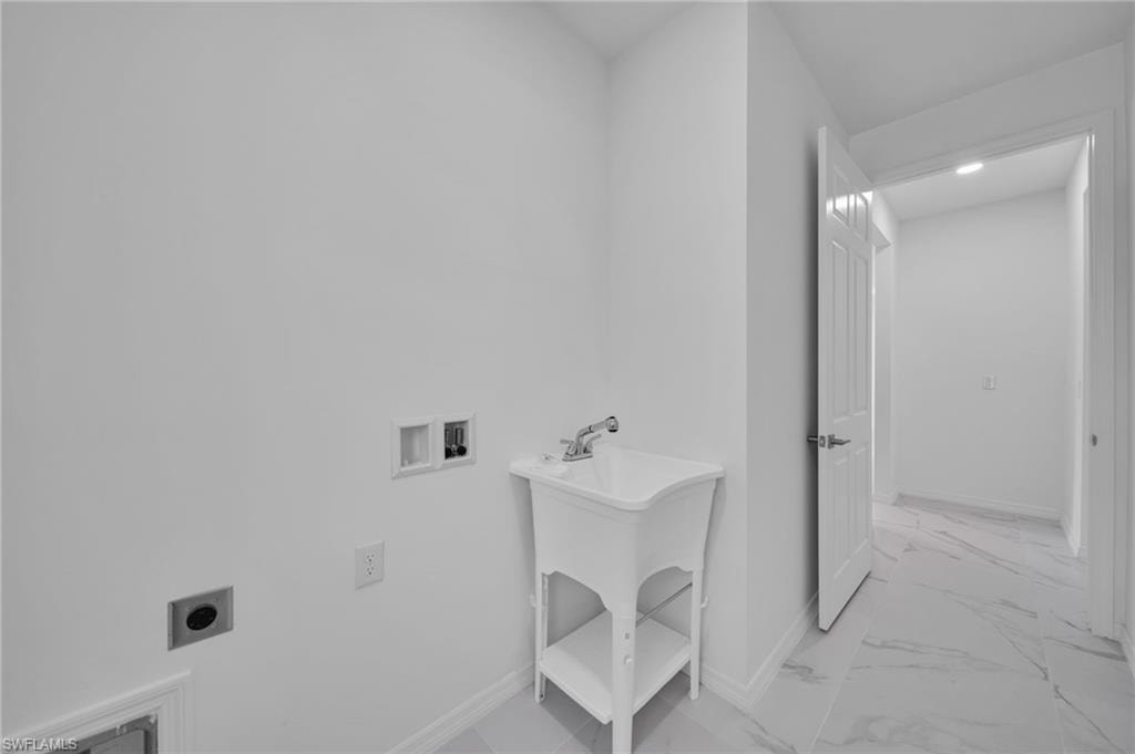 Laundry area featuring hookup for a washing machine, light marble finish flooring, and hookup for an electric dryer