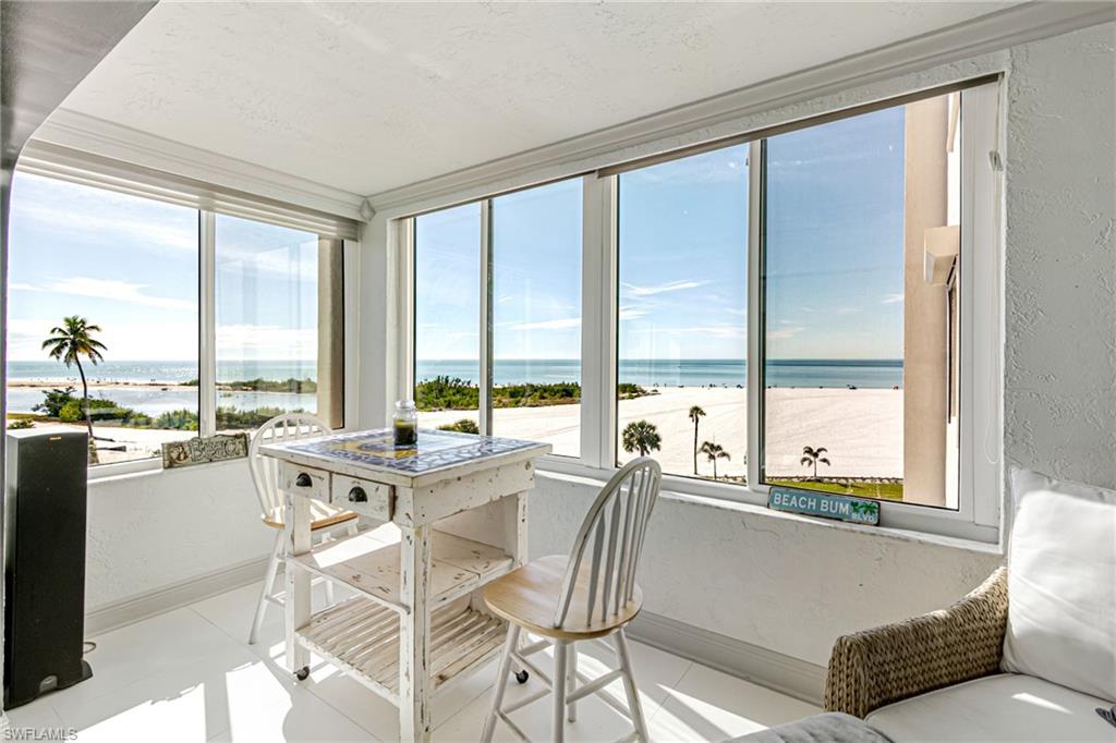 Sunroom / solarium featuring a textured wall and a water view