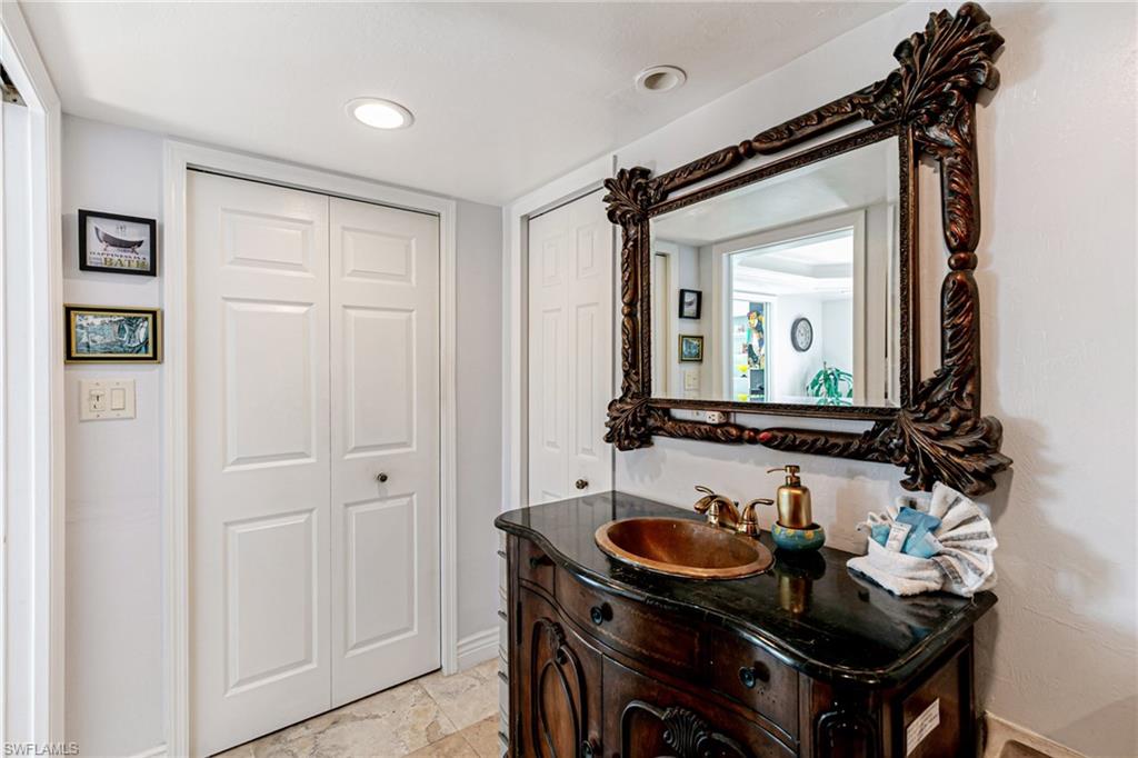 Bathroom with vanity and a closet