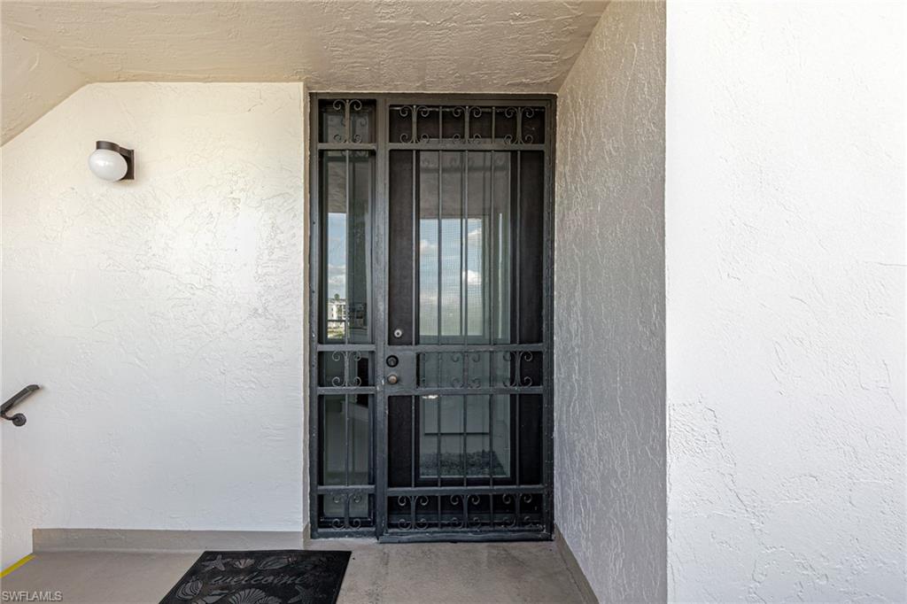 Entrance to property with stucco siding
