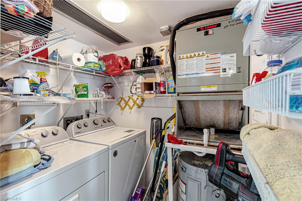 Laundry area with washing machine and dryer, water heater, and heating unit