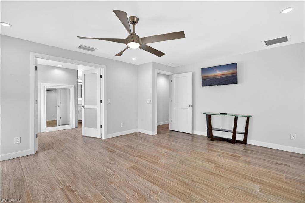Unfurnished bedroom with ceiling fan, light wood-type flooring, and recessed lighting
