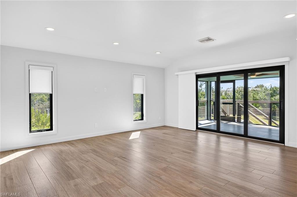 Bright, spacious living area with exceptional cross breeze when front and back porch doors are open.