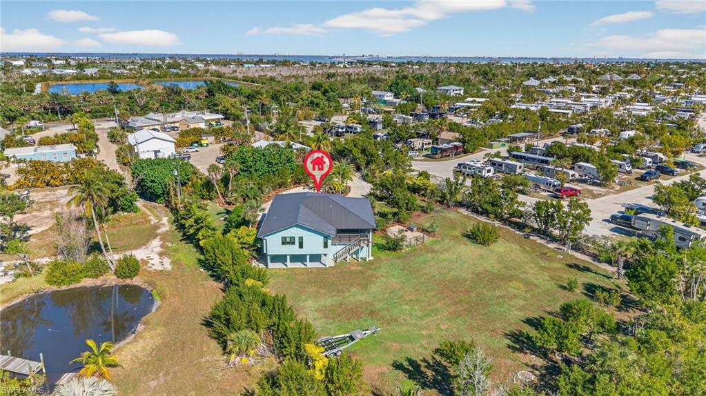 View of property location with a nearby body of water and nearby suburban area