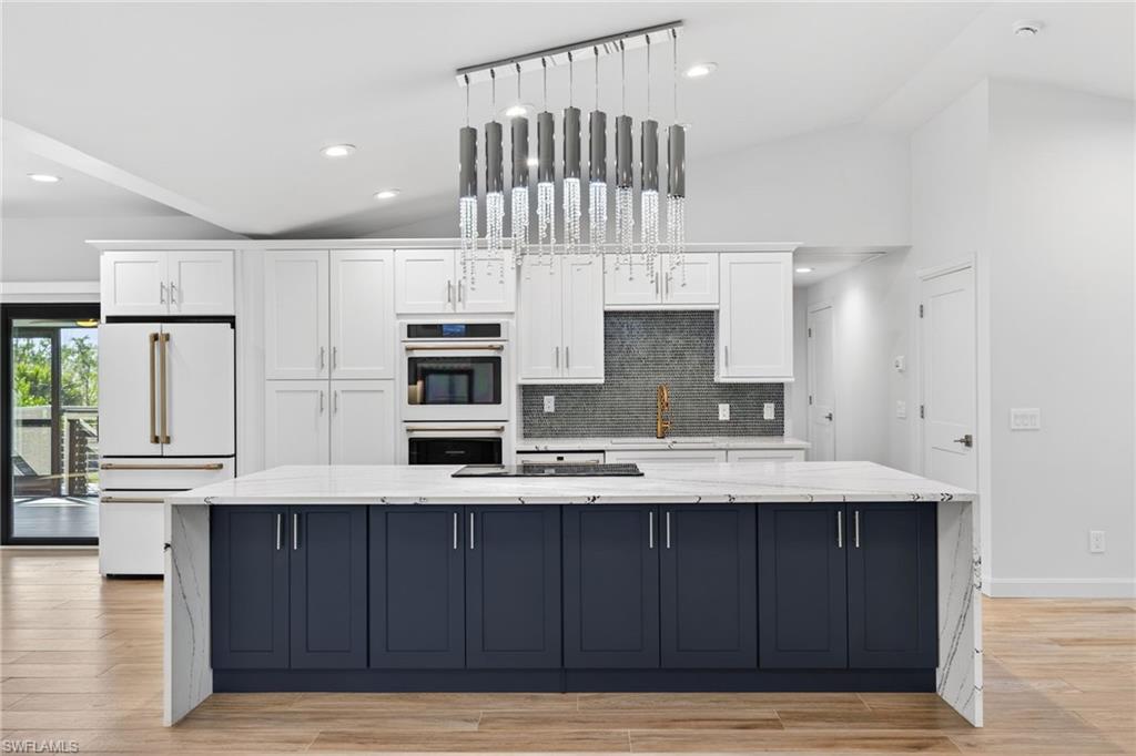 Extended breakfast bar seating, double oven, under counter built-in microwave, spacious cabinets.