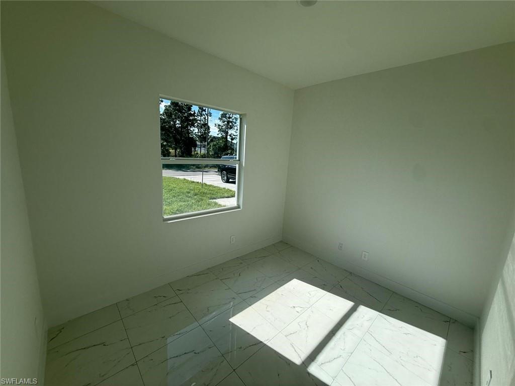 Unfurnished room featuring light marble finish flooring