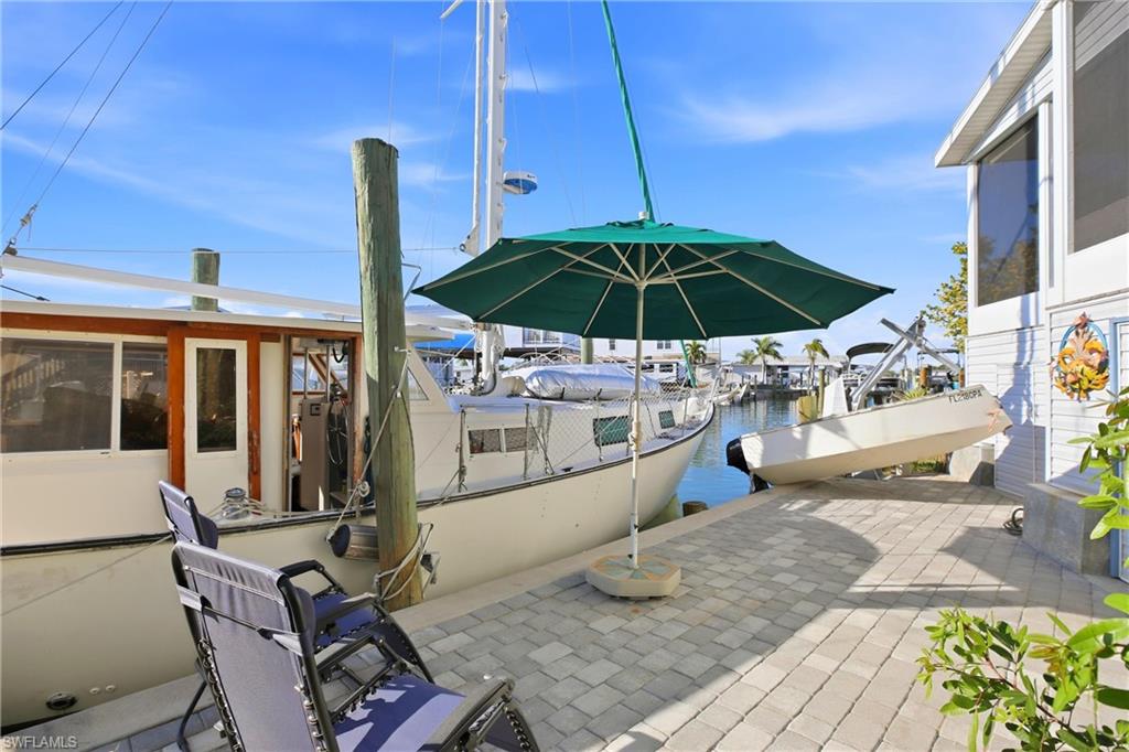 Dock with a water view and a sunroom
