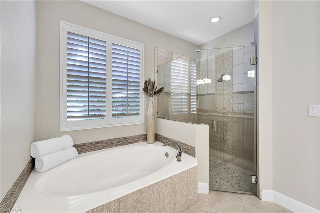 Bathroom featuring separate shower and tub and tile patterned floors