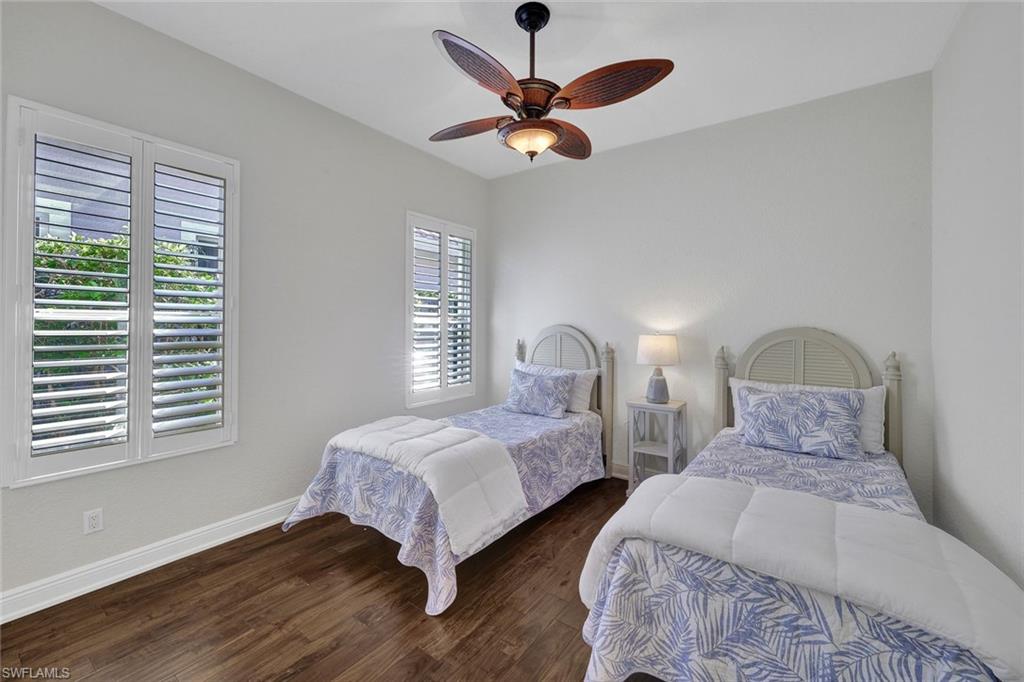Bedroom featuring ceiling fan and wood-type flooring
