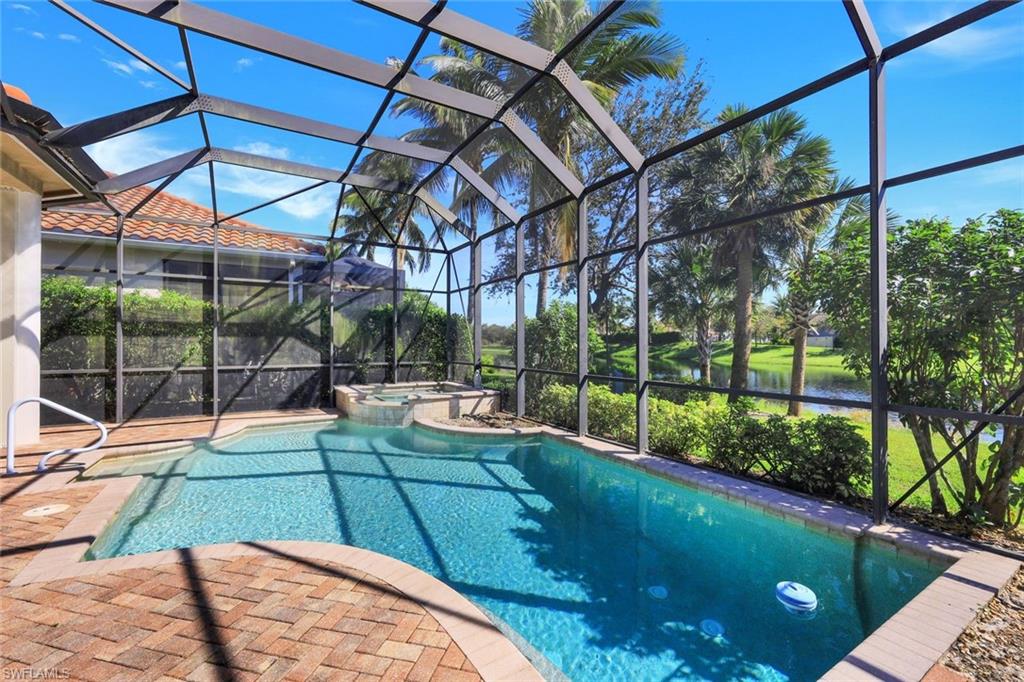 View of swimming pool featuring a lanai, an in ground hot tub, and a patio area