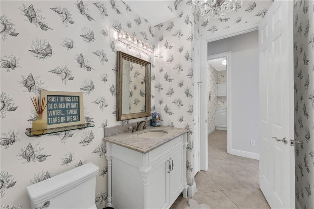Bathroom with toilet, tile patterned flooring, and vanity