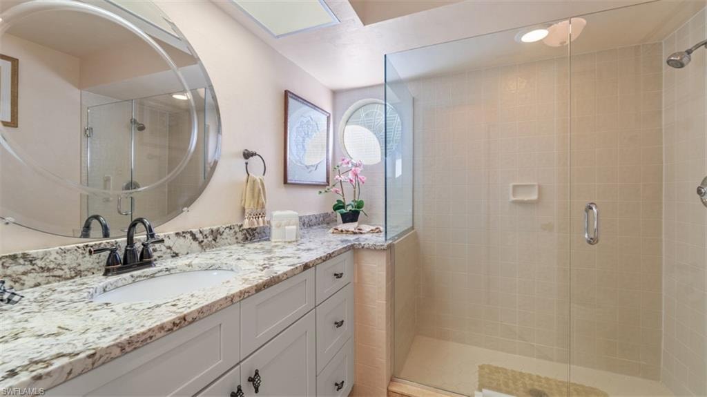 Full Guest bathroom with a stall shower and vanity