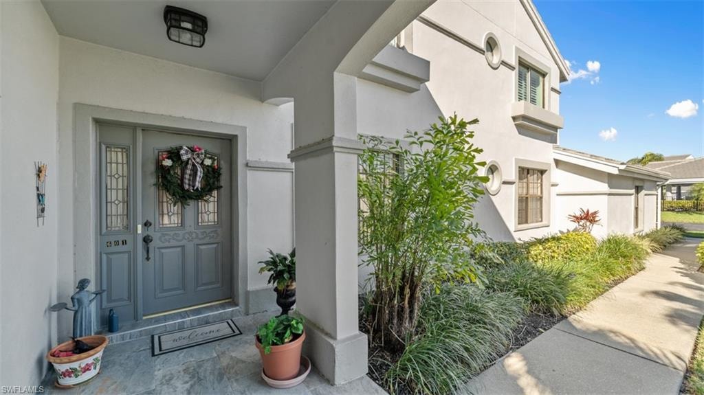 Entrance to property with stucco siding