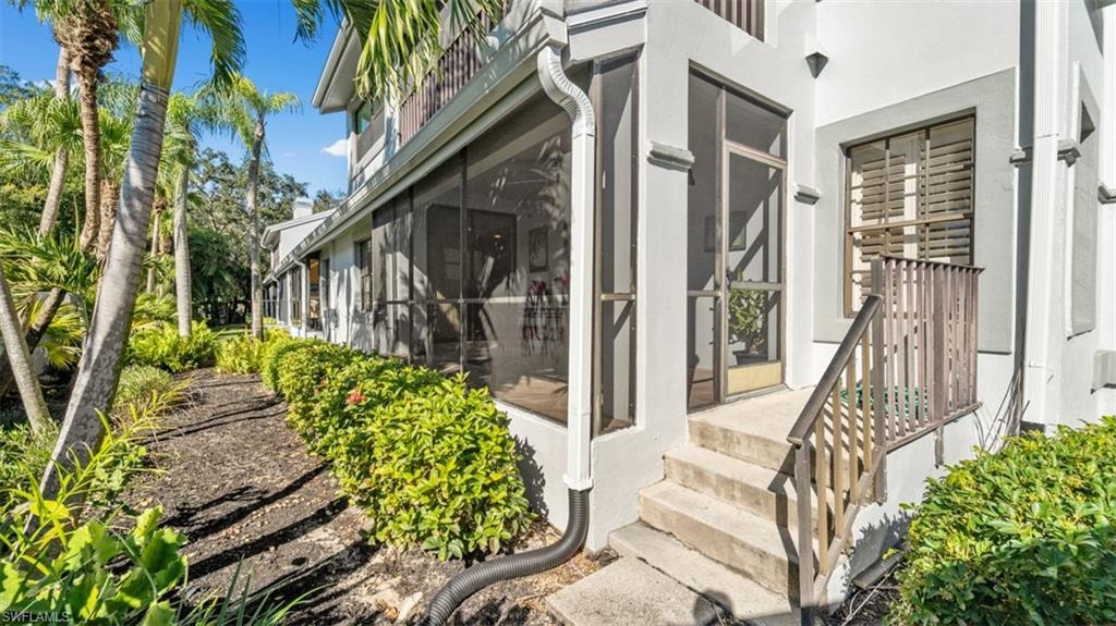 What a wonderful place to have potted plants & flowers. Back door featuring a sunroom and stucco siding
