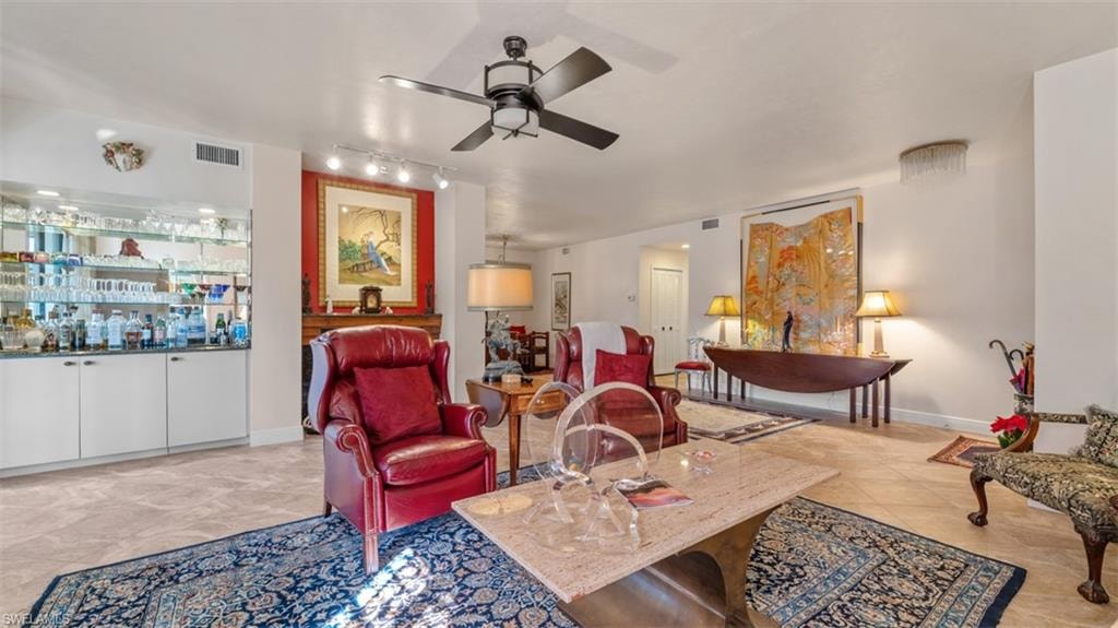 Living room featuring a ceiling fan and rail lighting