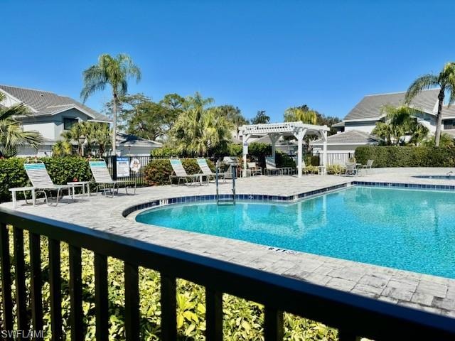 Community pool with a pergola and a patio
