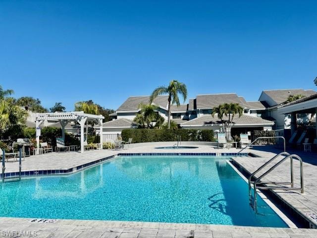Community pool with a pergola, a patio, and a grill