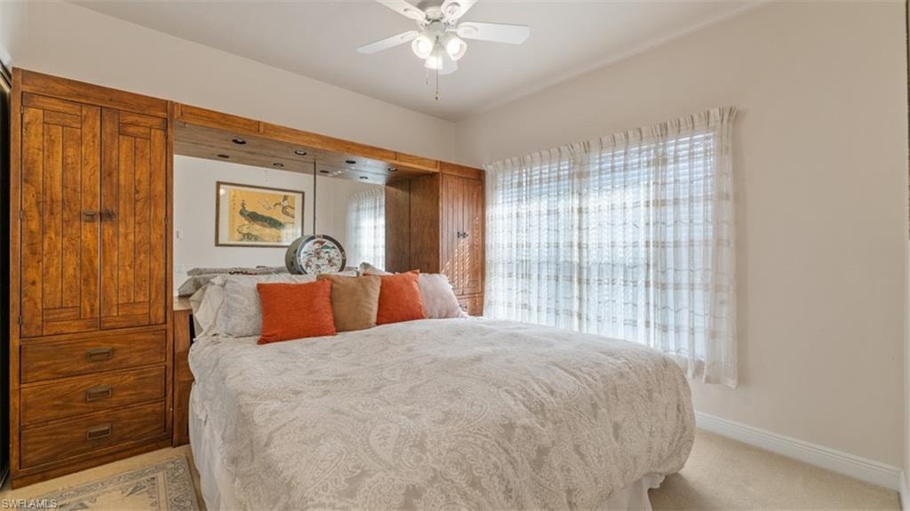 Guest Bedroom (1)with ceiling fan and light colored carpet