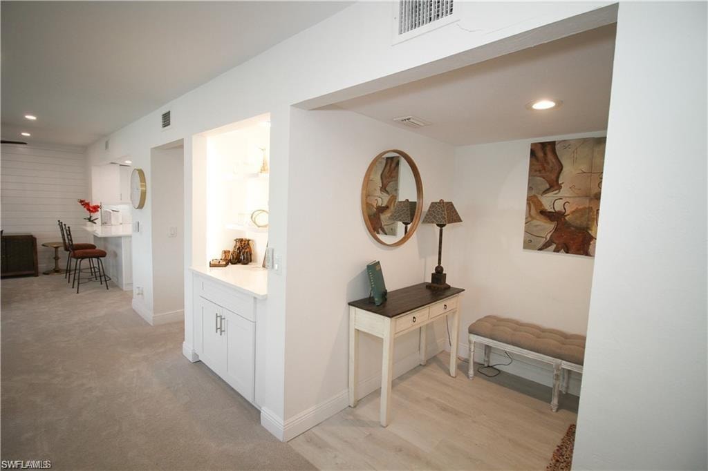 Hall with recessed lighting and light wood-style floors