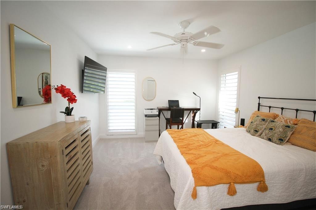 Bedroom featuring light carpet and ceiling fan