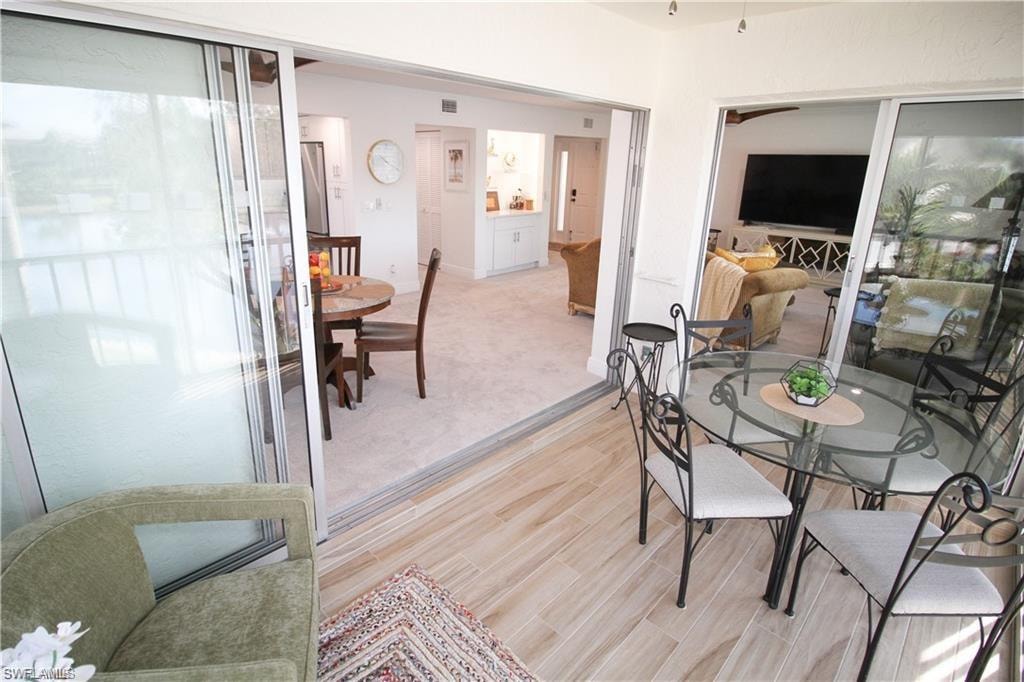 Dining room featuring light carpet and light wood-style flooring
