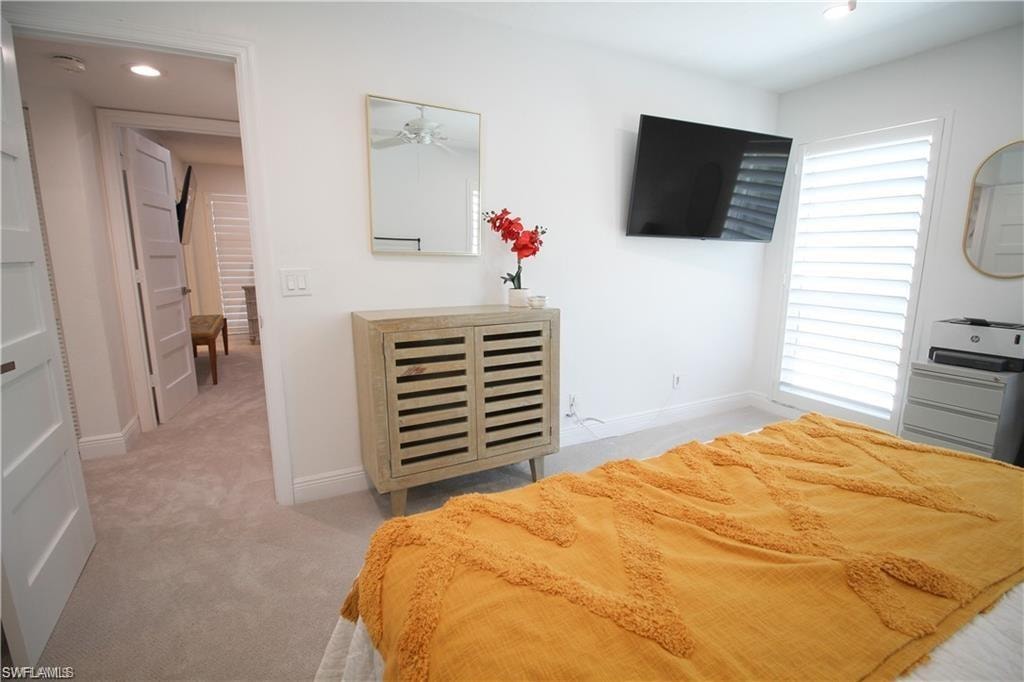 Bedroom with light colored carpet and recessed lighting