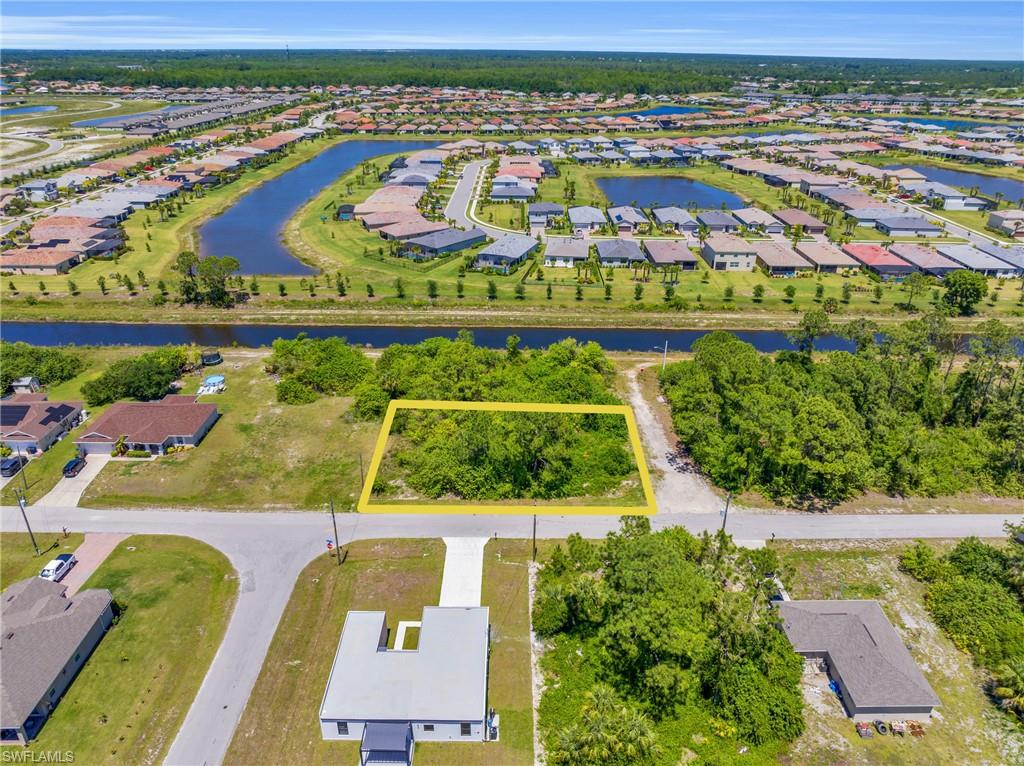 Aerial view of property and surrounding area with nearby suburban area and property parcel outlined