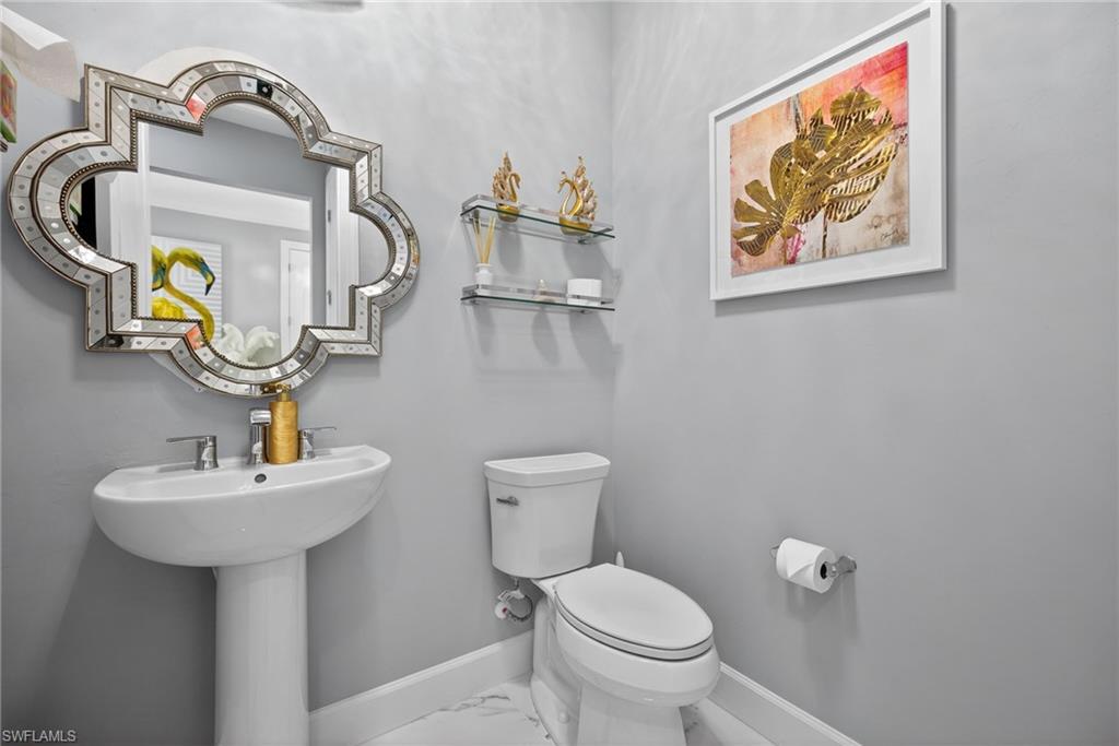 Bathroom with baseboards and marble finish flooring