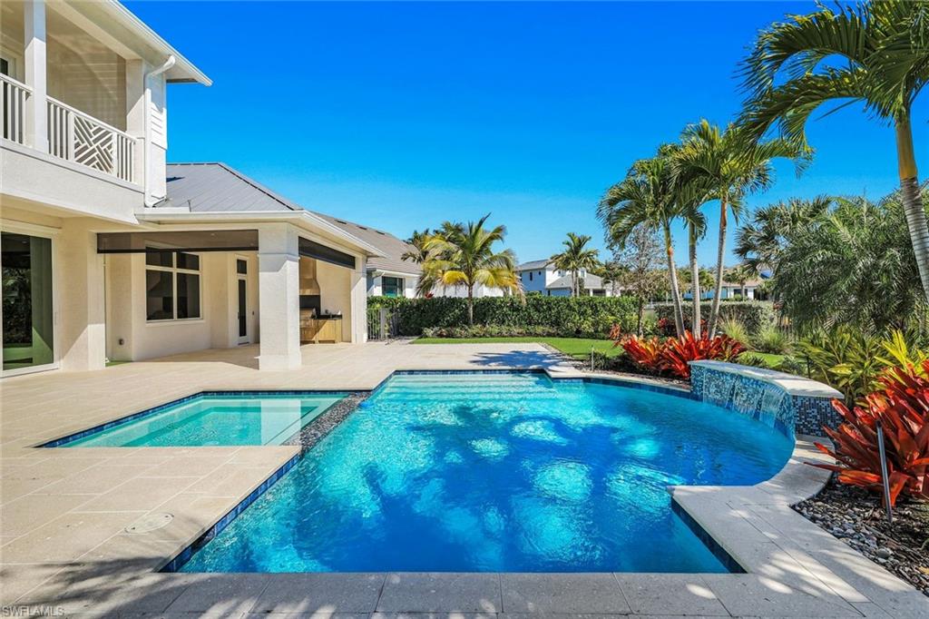 Combined pool / hot tub featuring a patio and a balcony
