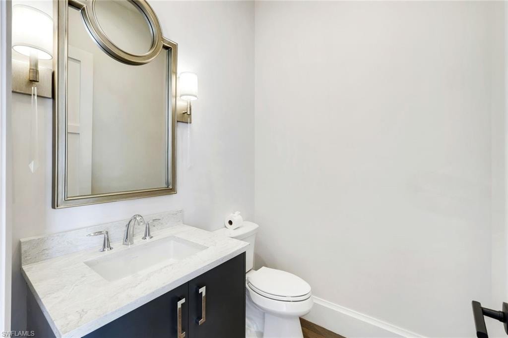 Half bath featuring vanity and toilet