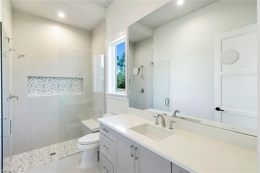 Full bathroom with a shower stall, vanity, and recessed lighting