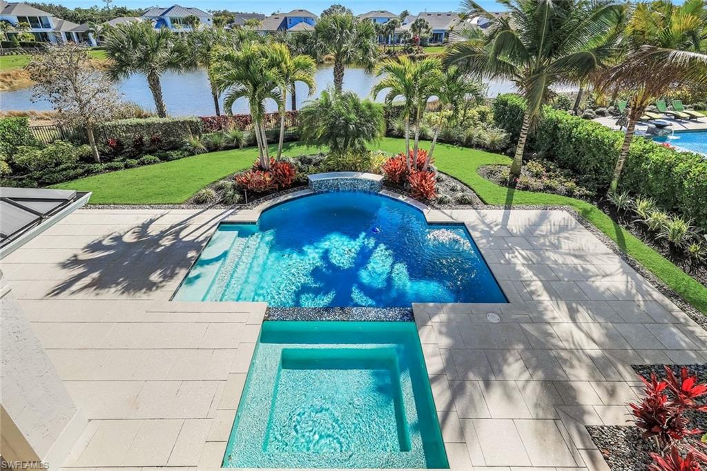 Integrated pool / spa with a fenced backyard, a residential view, and a patio
