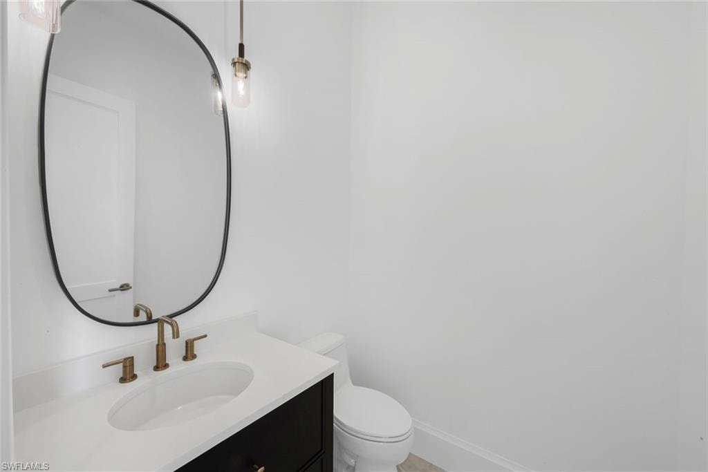 Half bath featuring vanity and toilet