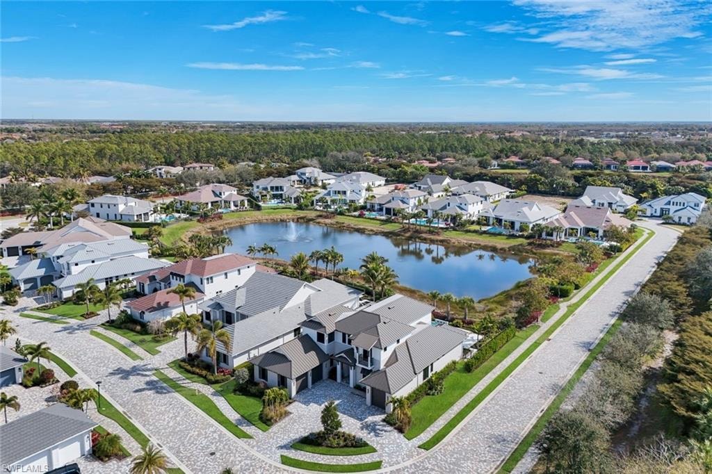 Aerial perspective of suburban area featuring a nearby body of water