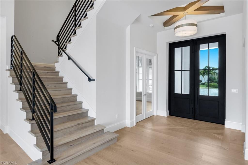 Entrance foyer with french doors and light wood-type flooring