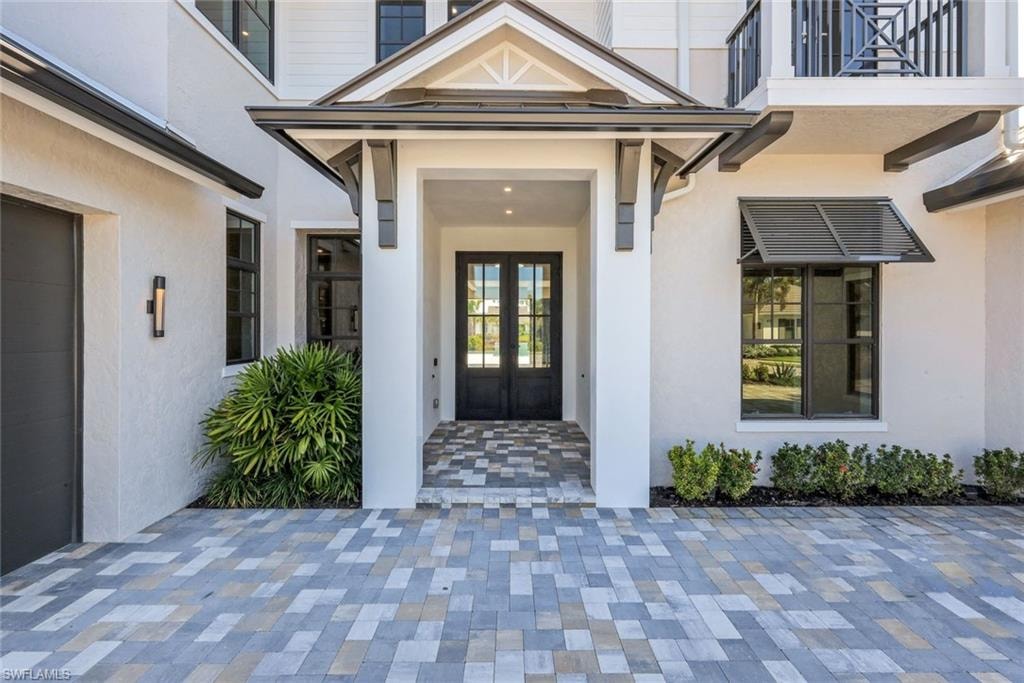 Entrance to property with stucco siding and french doors