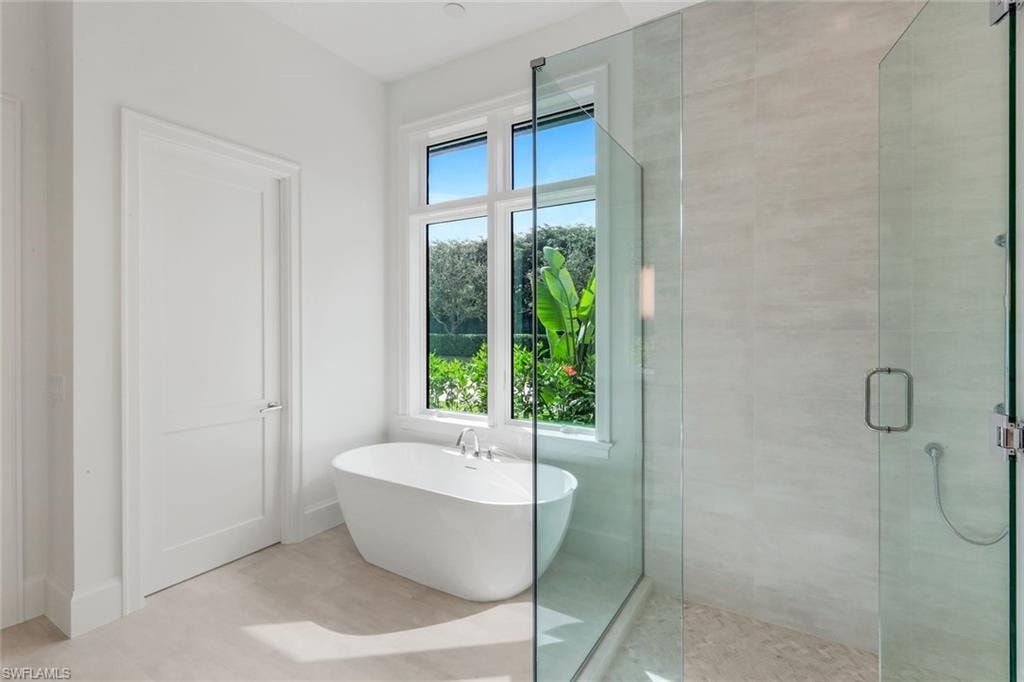 Bathroom with a stall shower and a soaking tub