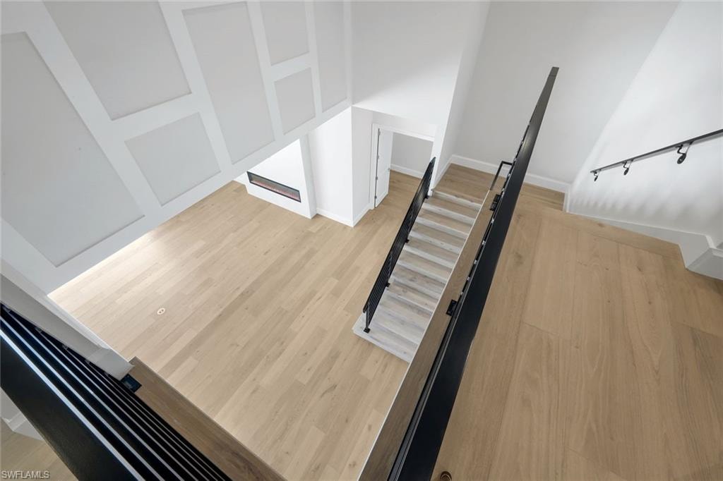 Stairway featuring wood finished floors