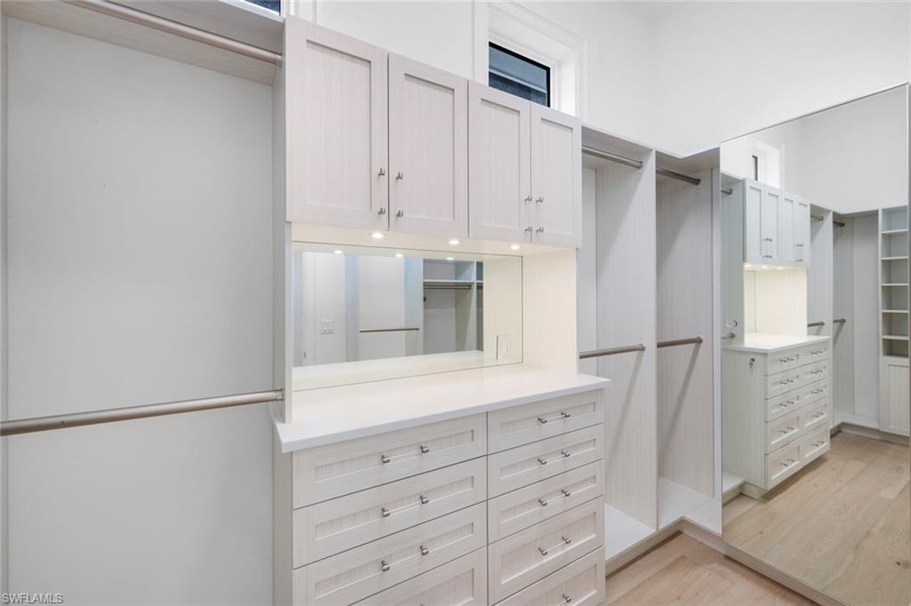 Walk in closet featuring light wood-style flooring