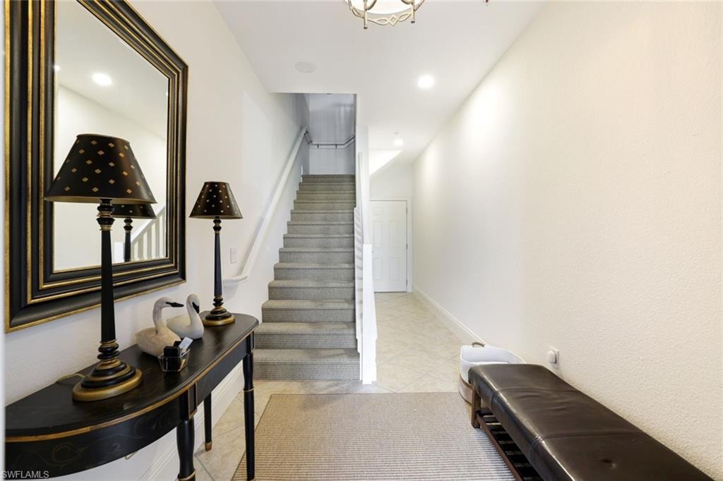 Staircase featuring recessed lighting and tile patterned floors