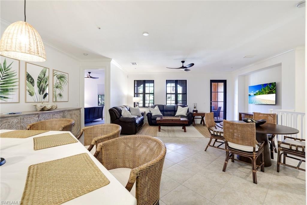 Dining space featuring ornamental molding, light tile patterned floors, and a ceiling fan