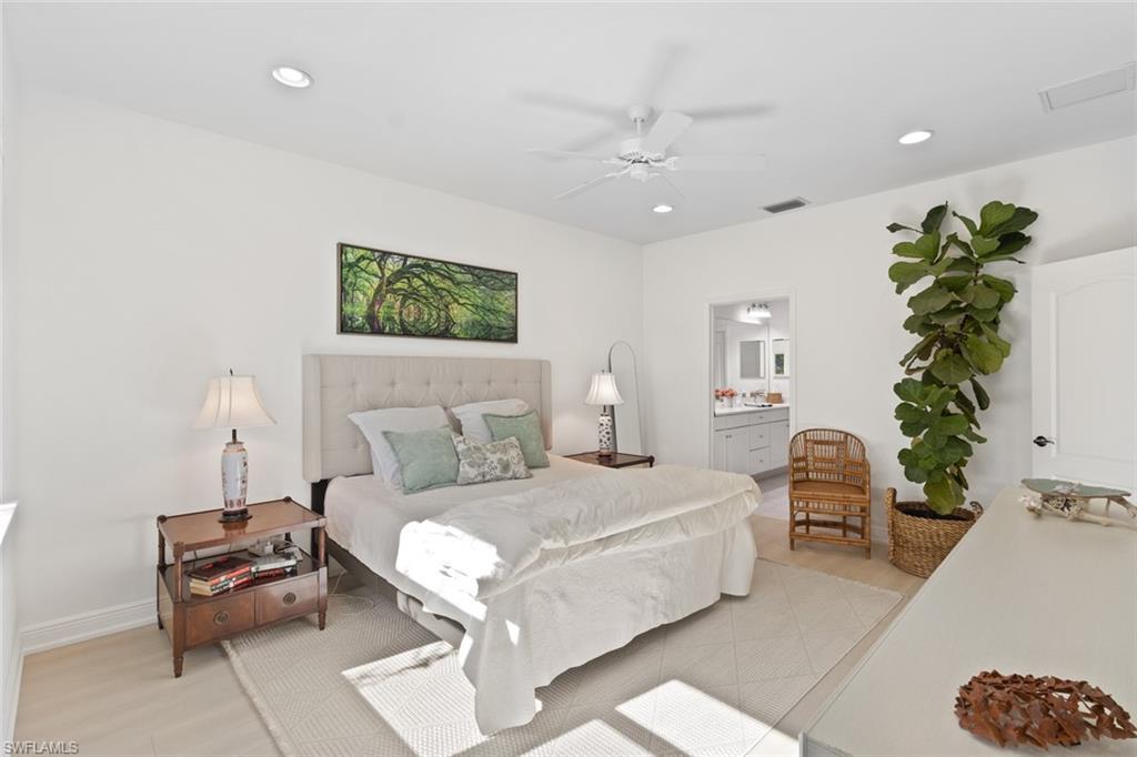Bedroom with a ceiling fan, ensuite bath, recessed lighting, and light wood-style floors