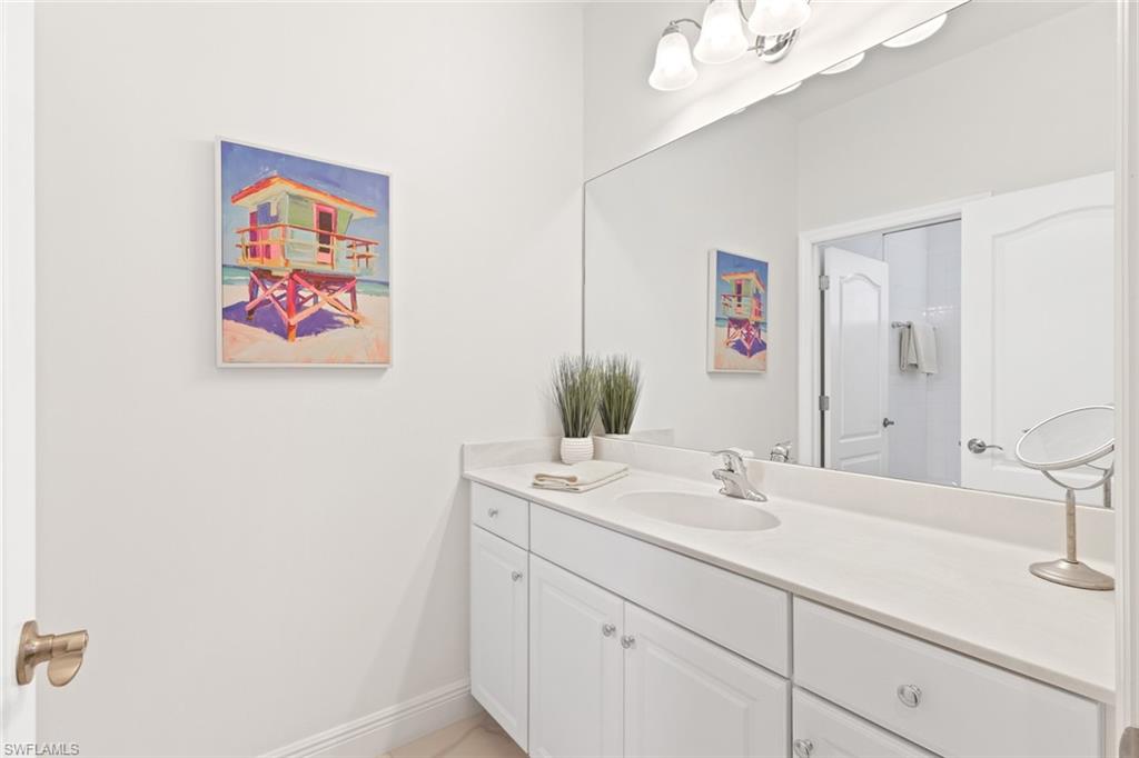 Bathroom featuring vanity and baseboards