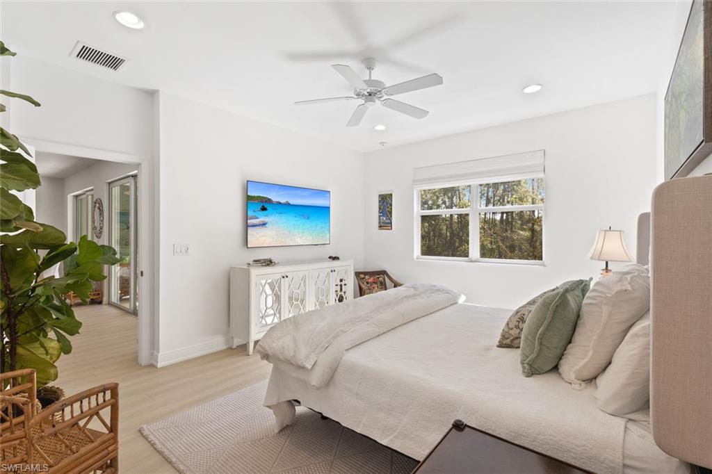 Bedroom featuring light wood finished floors, ceiling fan, and recessed lighting