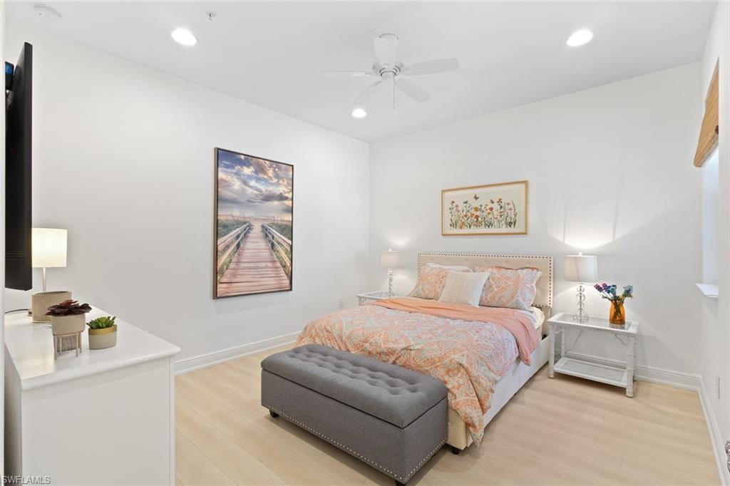 Bedroom featuring light wood-type flooring, ceiling fan, and recessed lighting