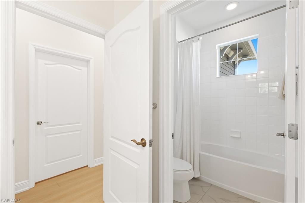 Full bath with shower / bath combination with curtain and toilet